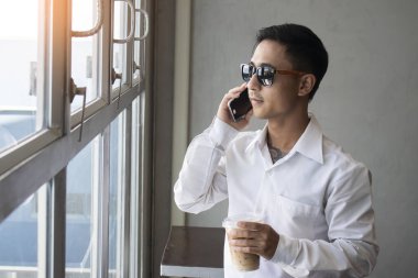 Kafede telefonla konuşan bir iş adamı.