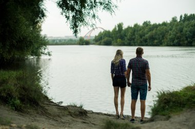 aşık adam ve kız zaman harcamak tekneler arka plan nehir kıyısında yürürken