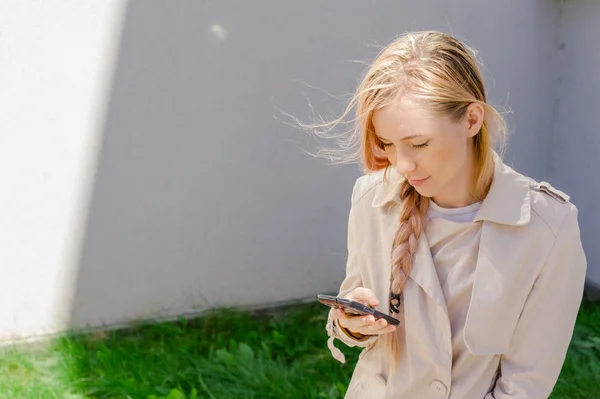 Ragazza alla moda guardando nel vostro smartphone invia sms, navigare l'interent, esagerando — Foto Stock