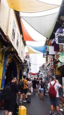 Hacı Yolu, Singapur. 15 Ağustos 2025. Her iki tarafında dükkanları olan birçok insan sokakta yürüyor.