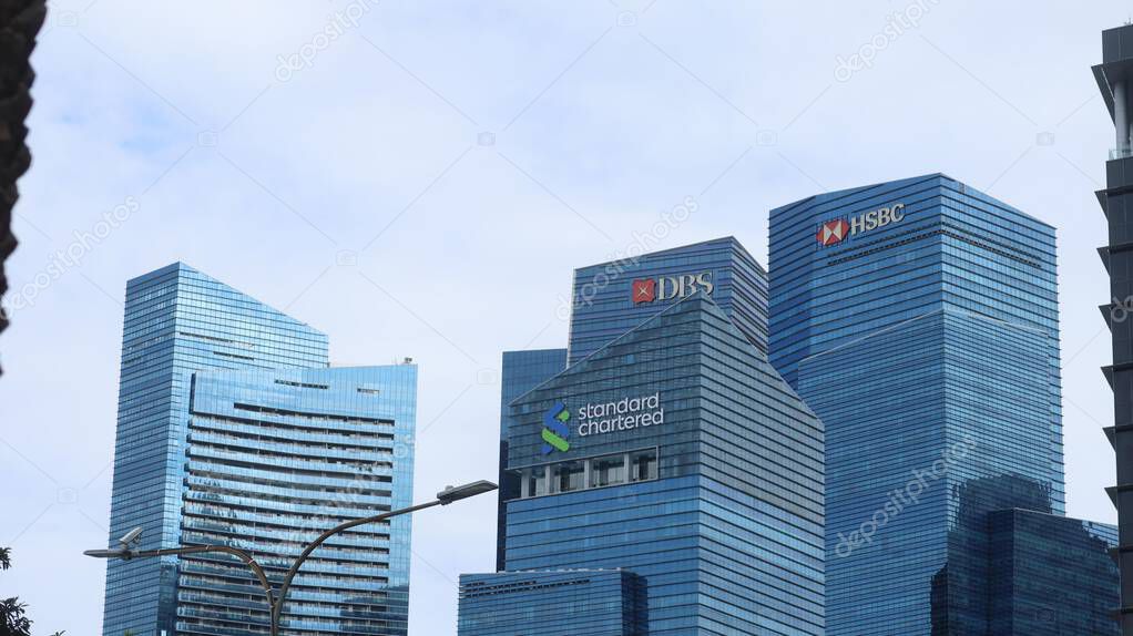 Marina Bay Financial Centre, Singapore- 13 Aug 2025: banks high rise skyscrapers with HSBC, Standard Chartered and DBS logo on the facade