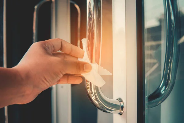 Stock image Homan hand  cleaning door handle with disinfectant  against bacteria And COVID 19