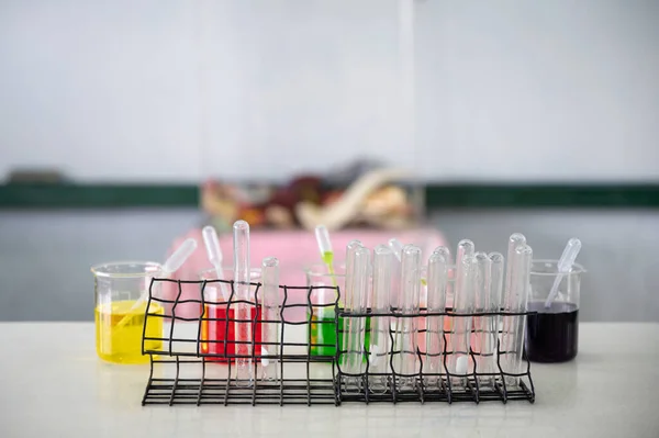 Set of test tube and colorful beaker and experimental substance on the desk at experiment laboratory in sciense class