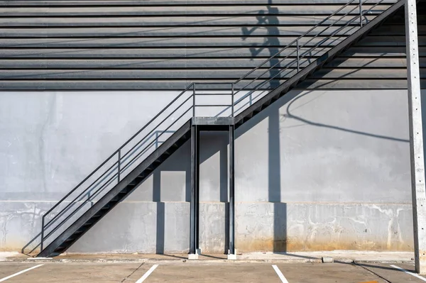 Black steel stair fire escape and car park at warehouse distribution