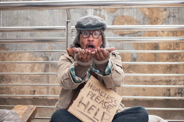 老脏无家可归的乞丐在桥上怒目而视地展示着手掌 — 图库照片