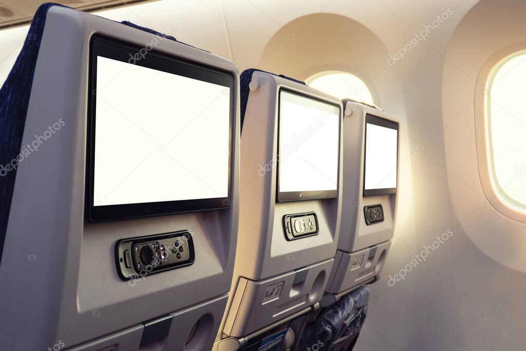 Back of row airplane seat with empty display and joystick by window