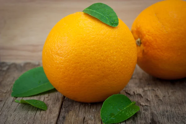 Orange, orange, orange on the wooden table in the background. — Stock Photo, Image