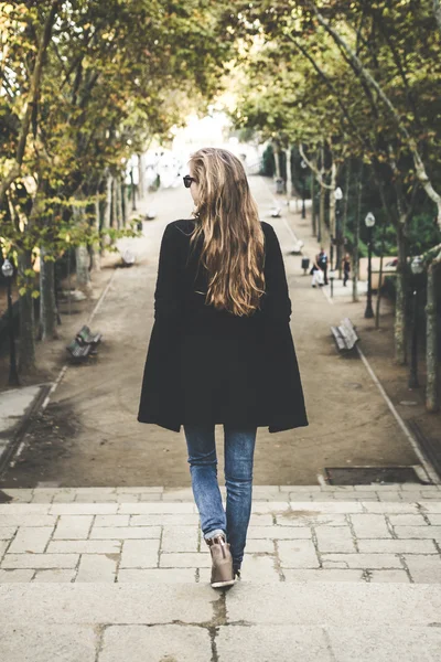 Woman walking down the stairs Stock Picture