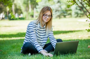Öğrenci Park çim üstünde laptop ile