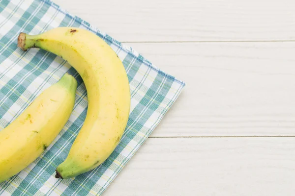 Fresh bananas on white wooden background — Stock Photo, Image