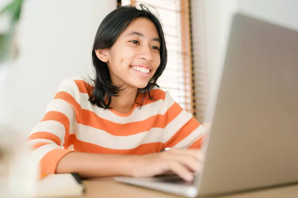 Asian girl student learning online via the internet with tutor on laptop, asian woman happy smile typing work on computer, Concept online learning at home