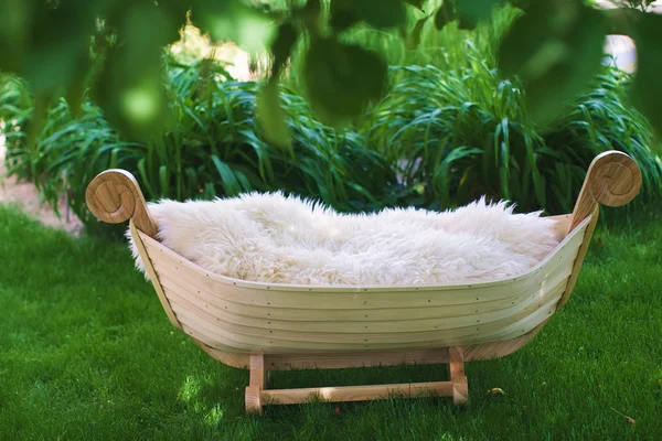 Wooden cradle in the shape of a boat — Stock Photo, Image