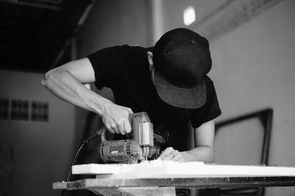 a man cutting foam board with Jig Saw