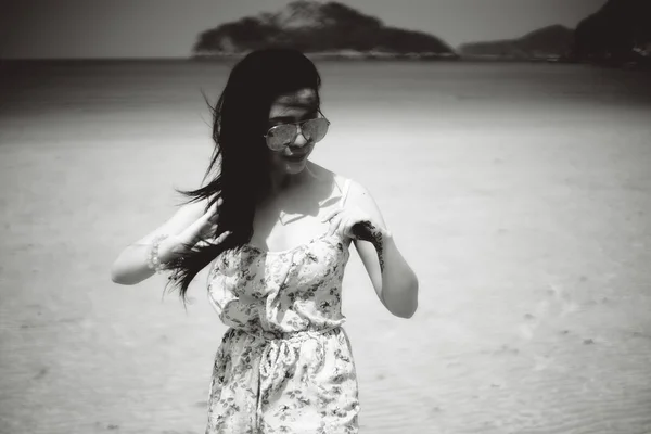 Asia woman at the beach and wind blow her hair, black and white vintage picture style, selective focus, soft focus effect, filtered image
