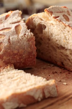 Artisan bread with decorative cuts and a porous crumb on a wooden surface  ideal for bakery branding