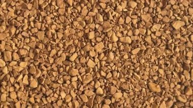 Gıda, içecek ve yaşam tarzı ürünlerini görselleştirmek için ideal, zengin kahverengi desenli çözünür kahve taneciklerinin yakın çekimi.