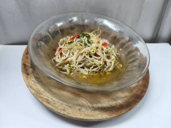 Şeffaf bir cam kasede lezzetli kızarmış fasulye filizleri. Tarifler, makaleler, kataloglar ya da diğer ticari amaçlar için ideal. Kapatın. Seçici odaklanma. Boşluğu kopyala.