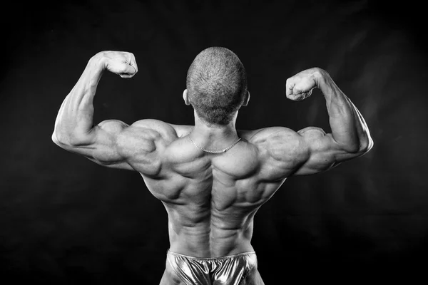 Indietro un uomo forte, bodybuilder . — Foto Stock