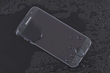 Water splash on Samsung Galaxy S7. Testing the Galaxy S7 water resistance IP68 standard clipart
