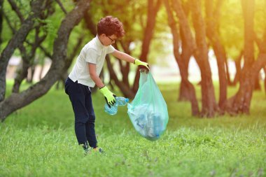Çöp tenekesini geri dönüşümlü çöp çöpü temizleme eğitimi. Doğa temizliği, gönüllü ekoloji yeşil kavramı. Genç erkekler ve çocuklar bahar ormanlarını gün batımında alırlar. Çevre plastik kirliliği