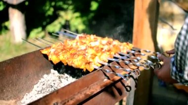 Doğada açık ateşte leziz barbekü pişirme süreci. Barbeküde leziz bir yemeği kızartıyoruz. Sokak yemeği. Ateşin üstünde domuz eti. Aile ve arkadaşlarla piknik zamanı.