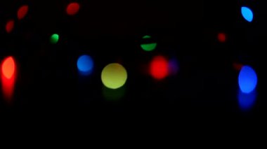 Yanıp sönen Noel çelengi. Stüdyo flaş lenslerini üst üste koy. Bokeh etkisi olan doğal ışık. Çerçeveleri kaplamak, şekillendirme videoları, geçişler için