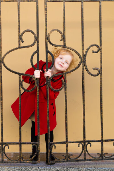 portrait of a little red-haired girl in city summer
