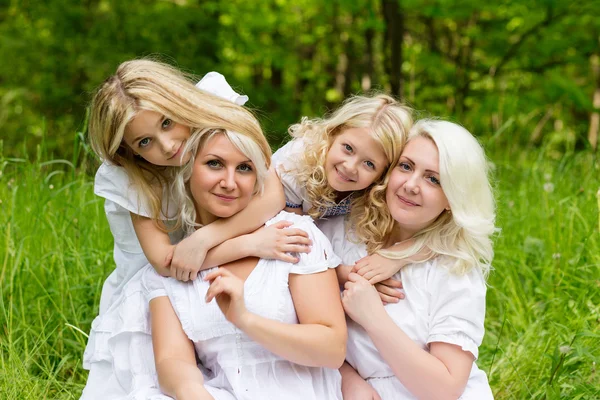 Família feliz descansando sobre a natureza no verão — Fotografia de Stock