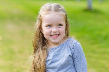 Uzun sarı saçlı sevimli bir kız portresi