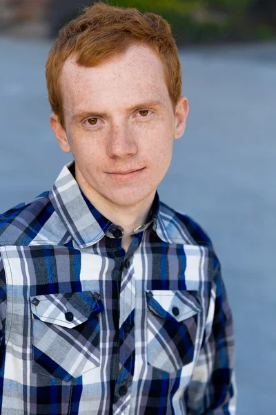 Redhead boy looks at you outdoors in summer — Stock Photo, Image