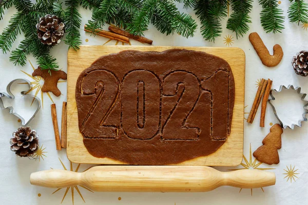 New Year lettering among fir trees and cookies
