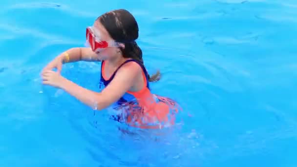 Mayolu ve su maskeli bir çocuk su parkının havuzunda yüzer.. — Stok video