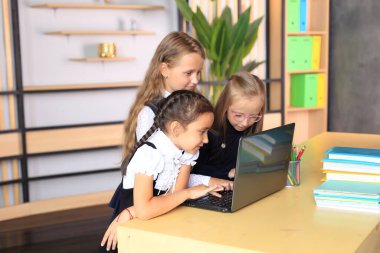 Sınıftaki dersten önce okul üniformalı genç bayan öğrenciler..