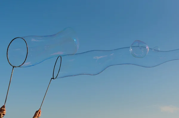 gigantic soap bubble toy with blue sky background