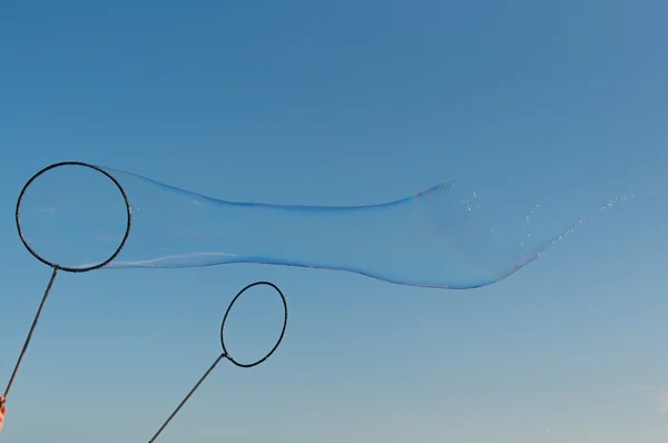 gigantic soap bubble toy with blue sky background