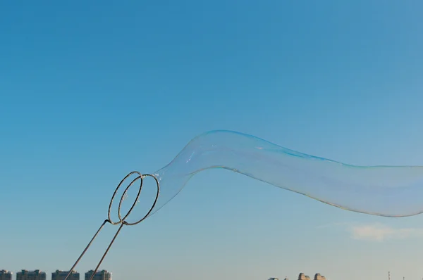 gigantic soap bubble toy with blue sky background