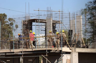Bricklayers working on a building under construction. Real estate development concept, workers at work