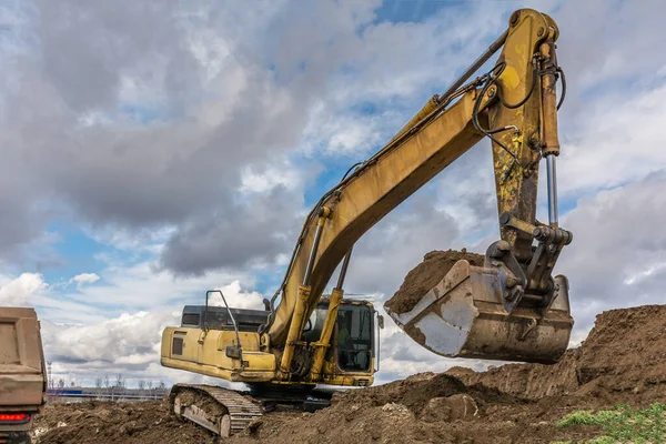 Excavator loading earth construction works