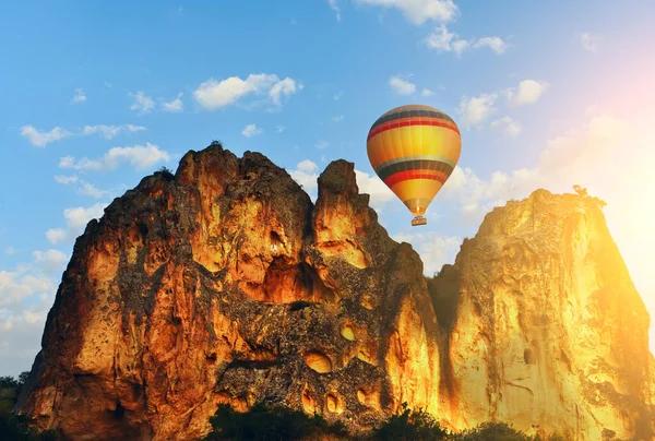 Aerial multicolored balloon in the sky above the rocks. Hot air balloon flight. Cappadocia. Turkey.