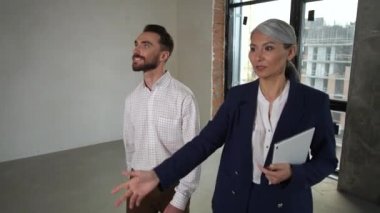 Broker talking with client on apartment for sale
