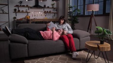 Annesini seven engelli bir kız video izliyor.