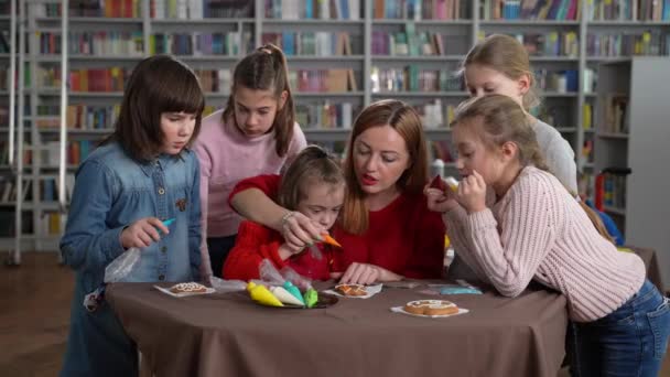 Δάσκαλος με κορίτσια διακόσμηση μπισκότα στην τάξη — Αρχείο Βίντεο