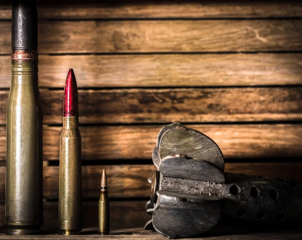 Weapons, cartridge on wooden background — Stock Photo, Image