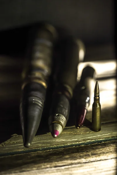 Weapons, cartridge on wooden background — Stock Photo, Image