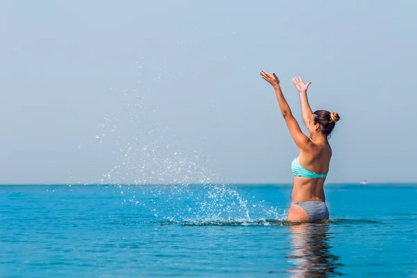 Beautiful girl, standing alone in the sea