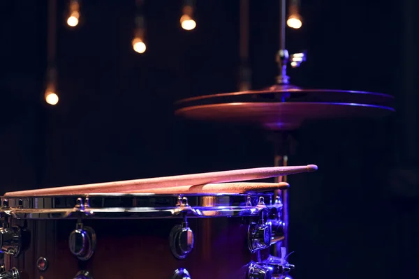 Part of a drum kit in the dark on a blurred background with boke.