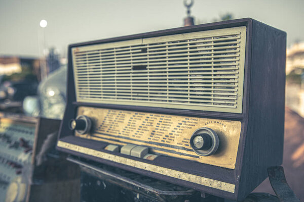 Close up of an old vintage radio receiver on a blurred background.