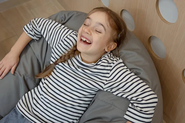 Cheerful Little Girl Resting Comfortable Beanbag Chair — Stock Photo, Image