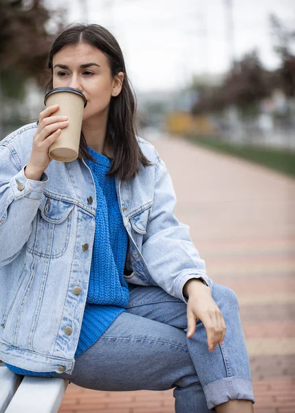 Junge Frau Trinkt Kaffee Auf Einer Bank Park Sitzen — Stockfoto