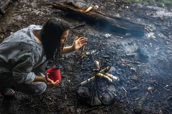 Ein Mädchen Mit Einer Tasse Der Hand Heizt Das Feuer — Stockfoto